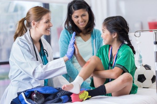 Image of a doctor helping a child